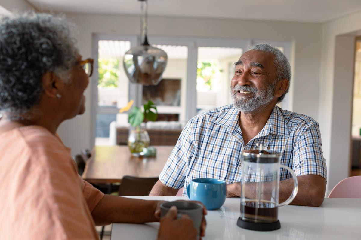 senior couple discussing the benefits of reverse mortgages